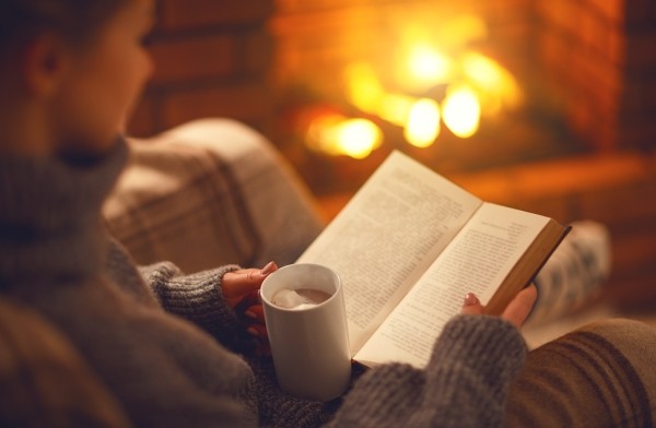 Buch vor dem Kamin lesen