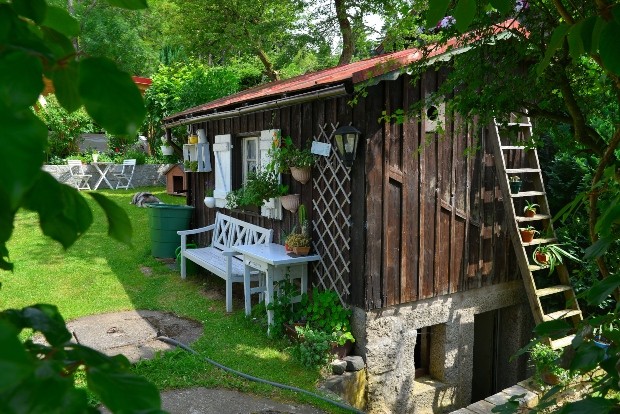 Gartenhäuschen mit Möbeln und Bepflanzung - Schrebergarten gestalten